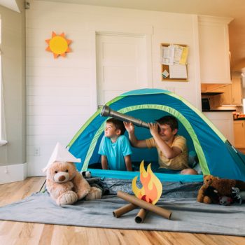 Boys Exploring with Telescope Indoors